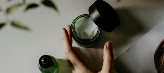 person-touching-black-plastic-bottle.jpg person touching black plastic bottle
